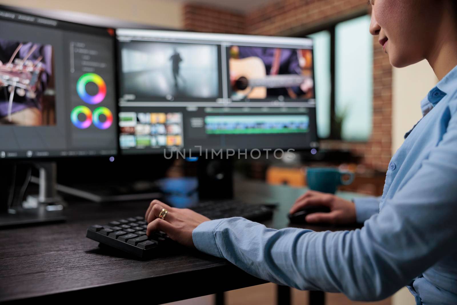 Close up shot of professional videographer sitting at desk while enhancing movie footage using specialized software. by DCStudio