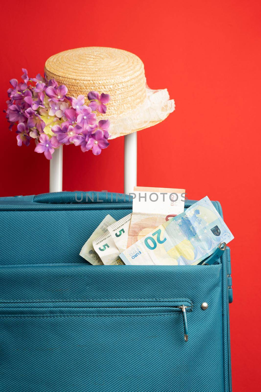 travel suitcase, hat and ticket isolated on red background. high quality photo