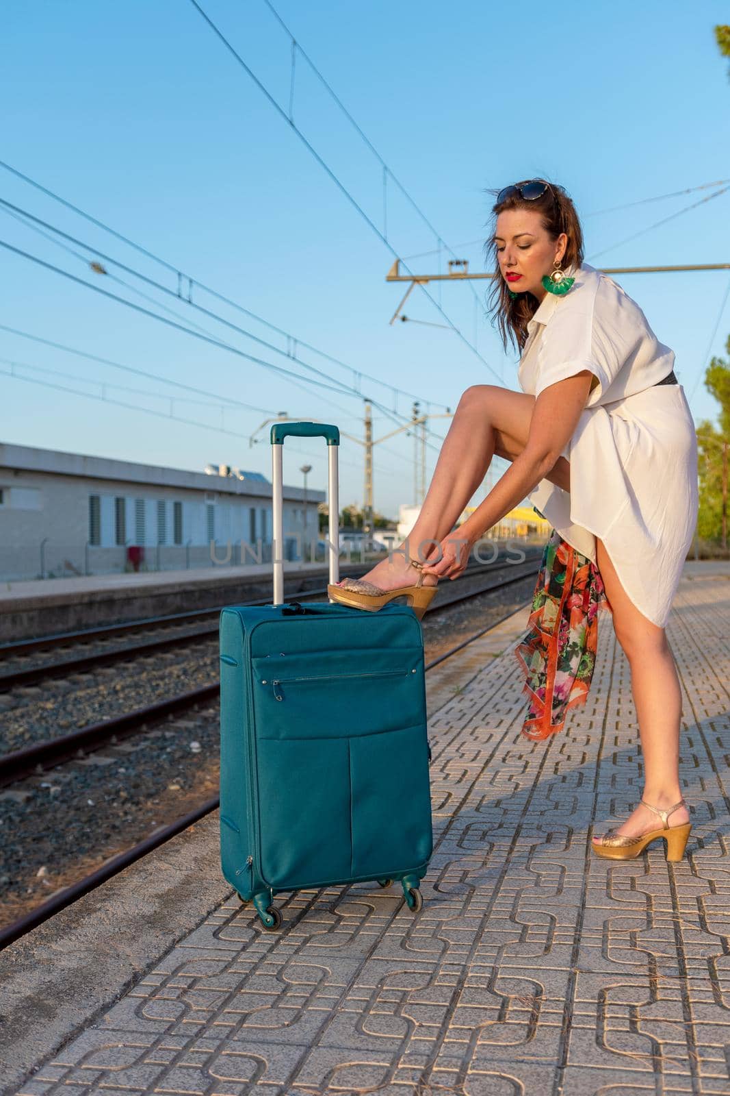 Girl with a suitcase at the train station by Mareno