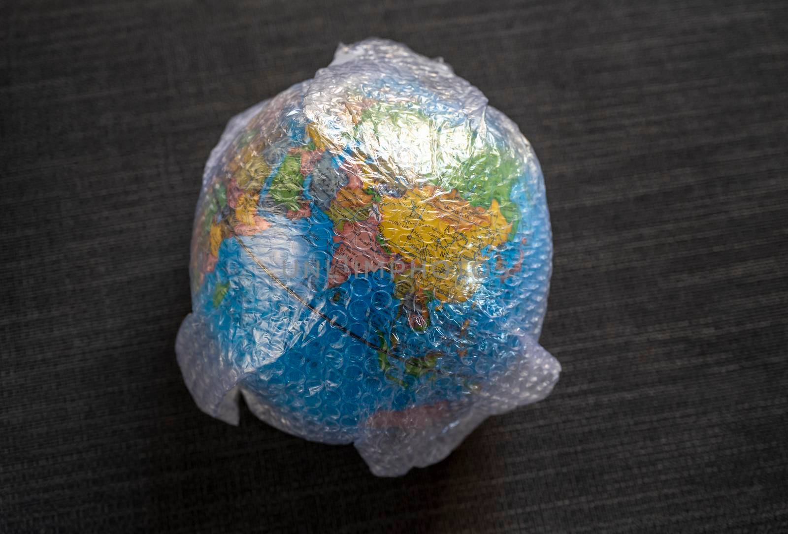 Globe wrapped in bubble wrap plastc still life