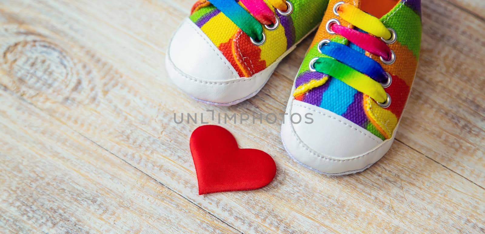 Baby booties and heart on a light background. Selective focus. by yanadjana