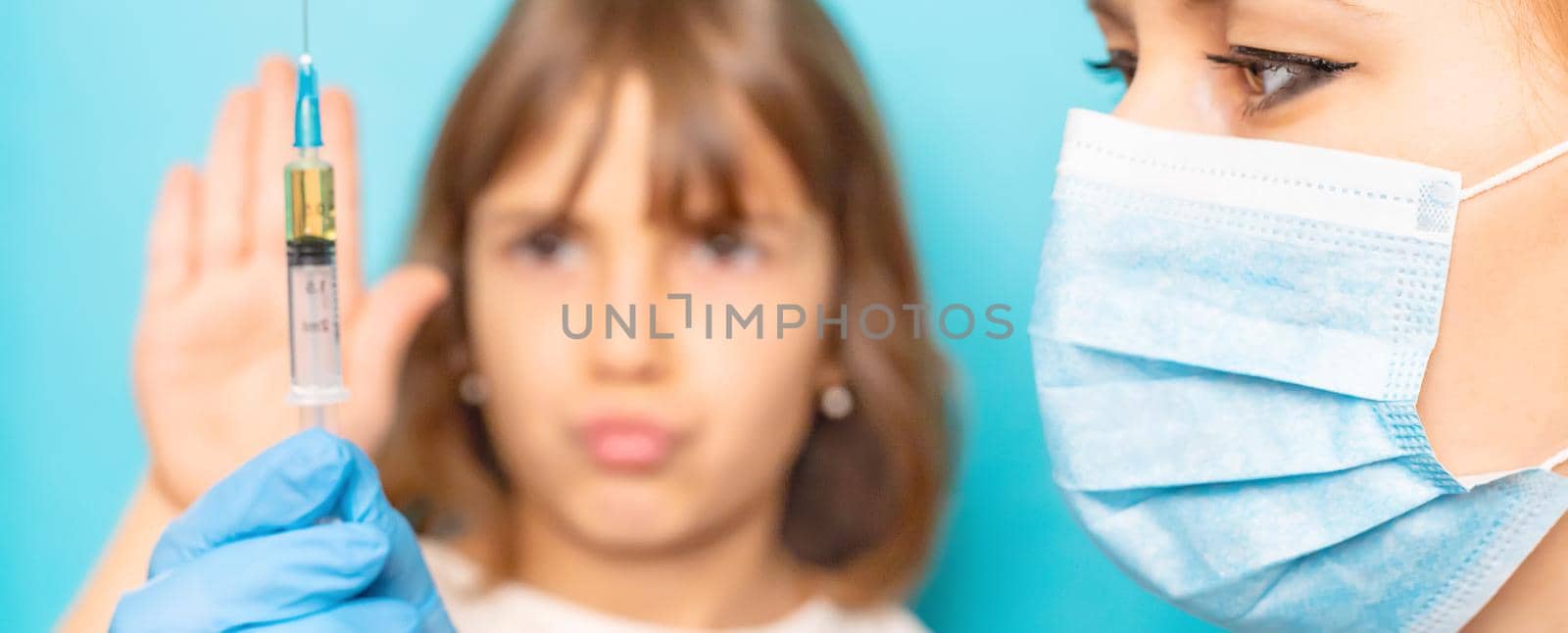 The child is injected into the arm. Selective focus. by yanadjana