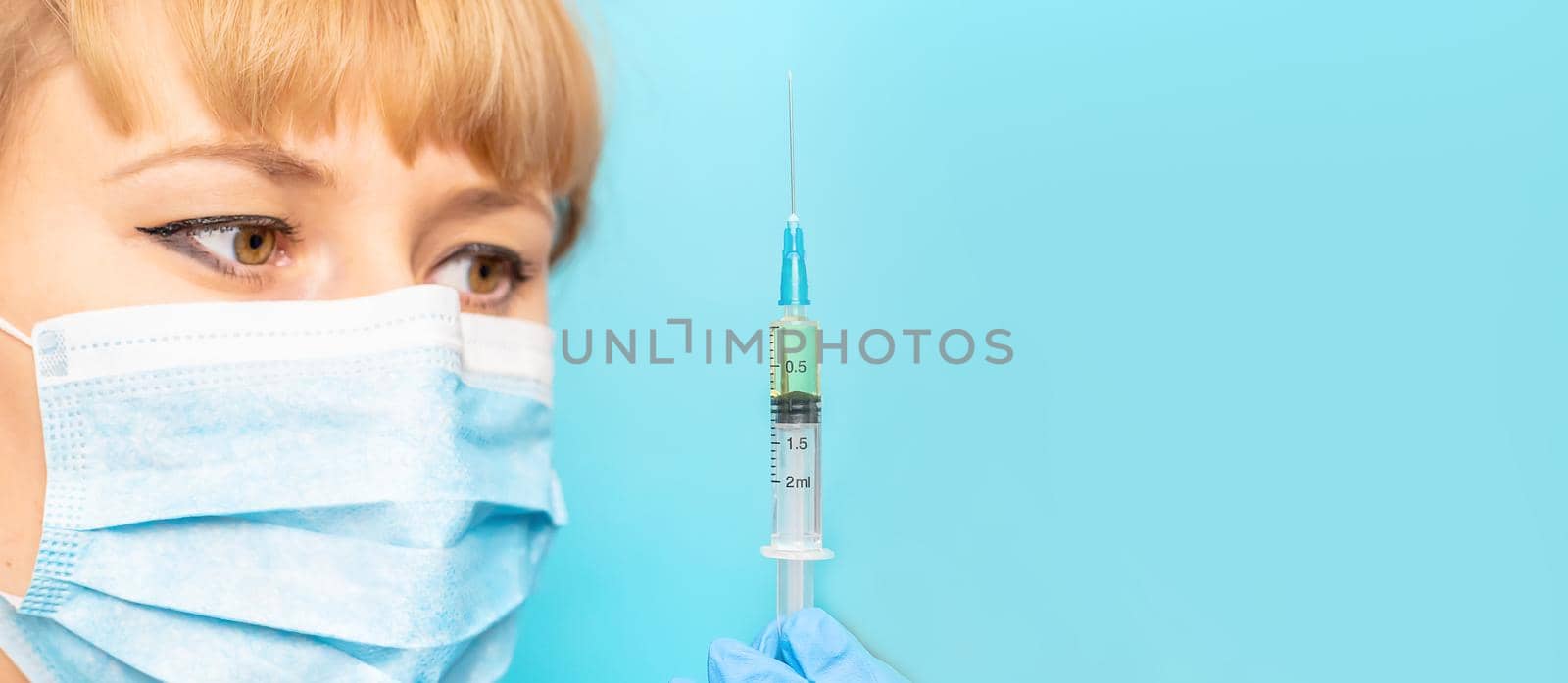 Doctor with a syringe in his hands. Selective focus.