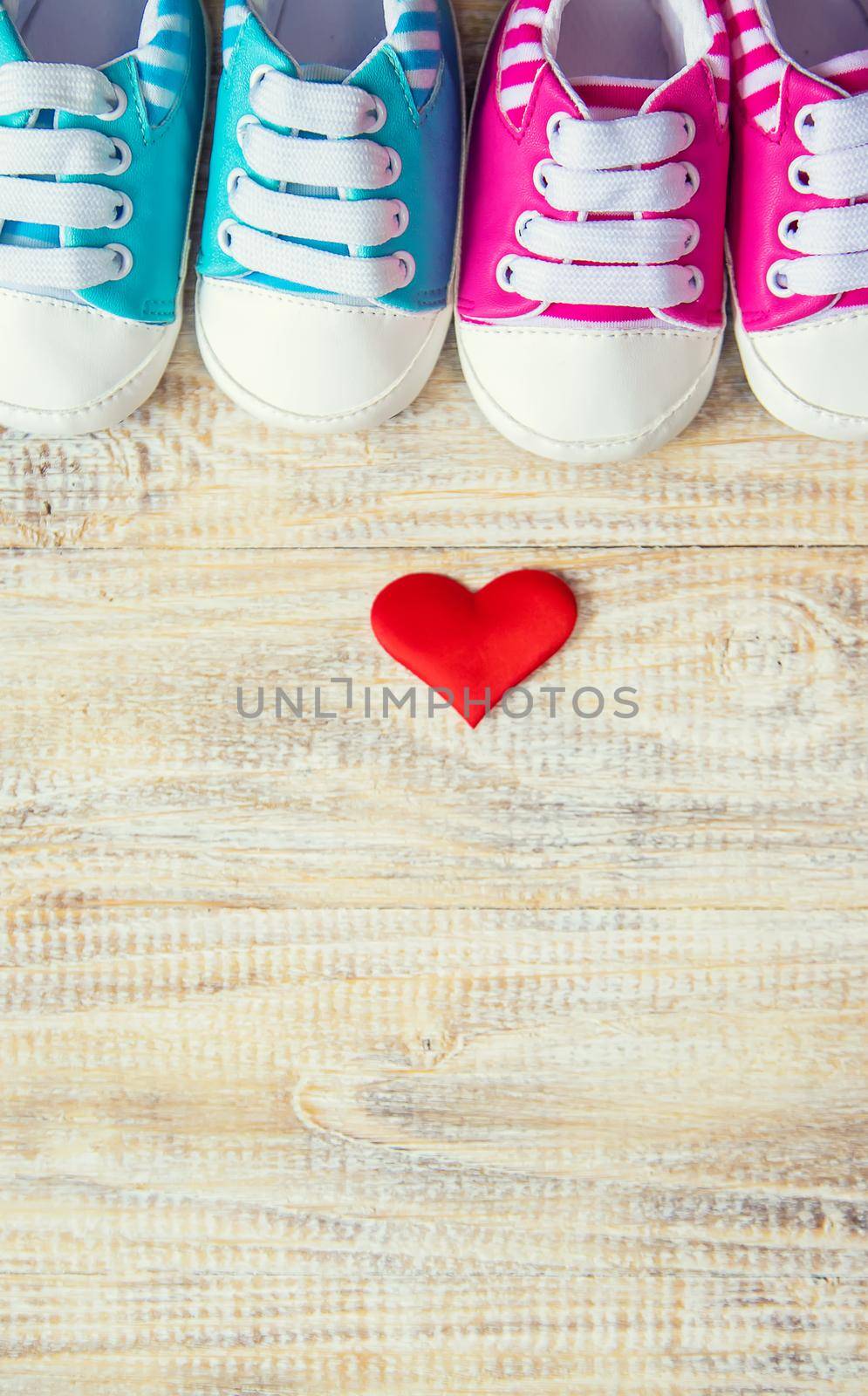 Baby booties and heart on a light background. Selective focus. nature.