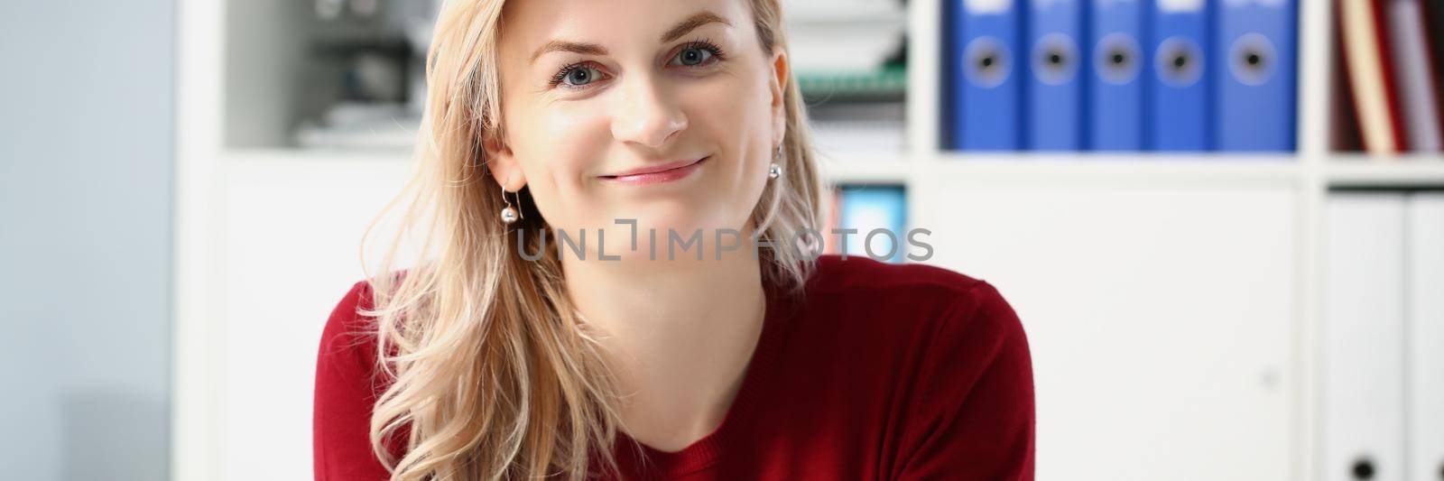 Beautiful young woman office worker posing in personal cabinet by kuprevich