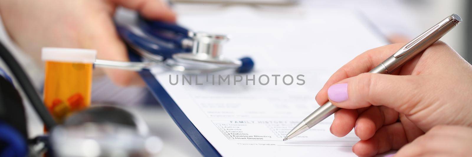 Woman put signature on paper with prescriptions for diagnostics by kuprevich