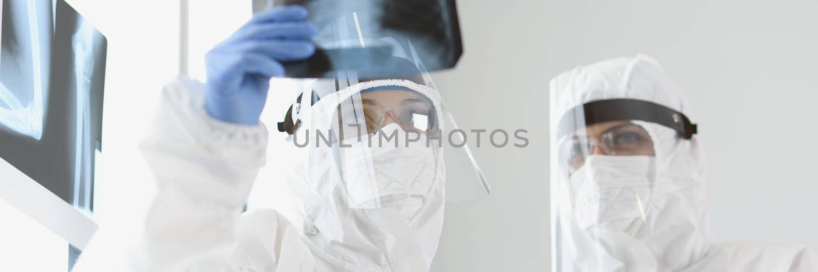 Portrait of qualified doctors examine x ray of patient lungs in clinic. Medical workers got result and analyze medical history. Healthcare, checkup concept