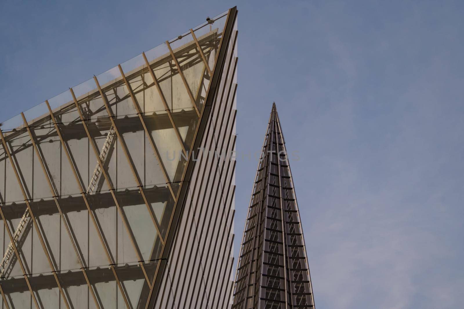 Russia, St. Petersburg, 10 June 2022: The spire of skyscraper Lakhta center of the gas company Gazprom at sunset, glass and iron facade. High quality photo