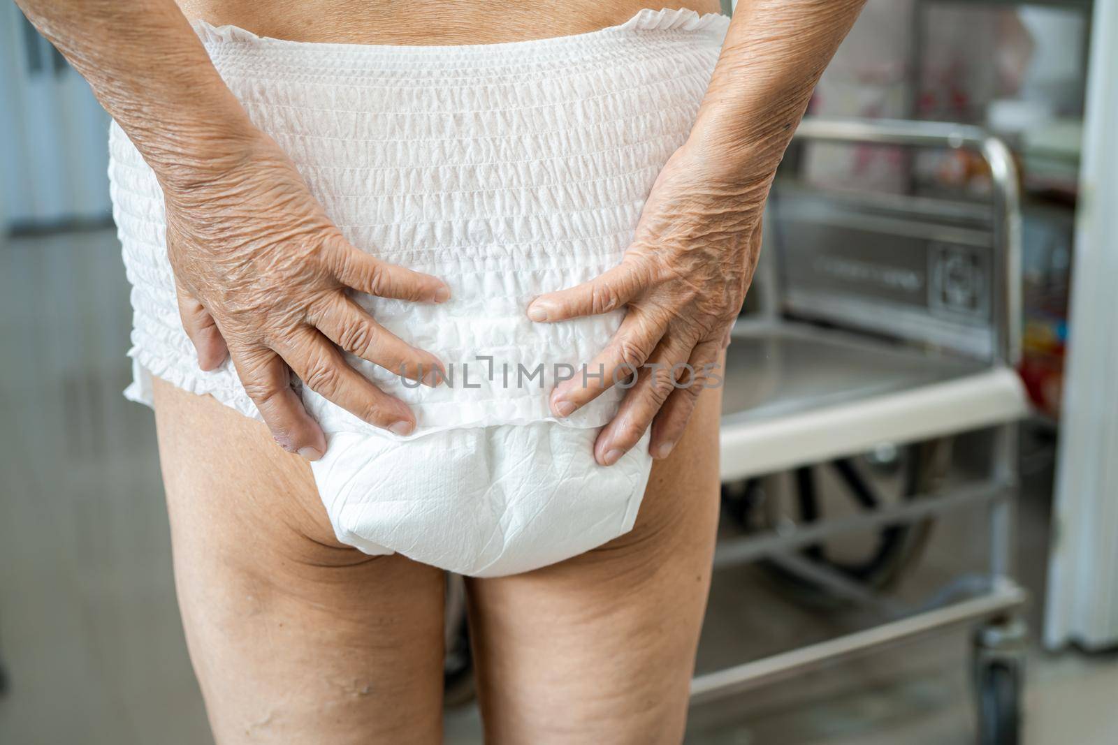 Asian senior or elderly old lady woman patient wearing incontinence diaper in nursing hospital ward, healthy strong medical concept.