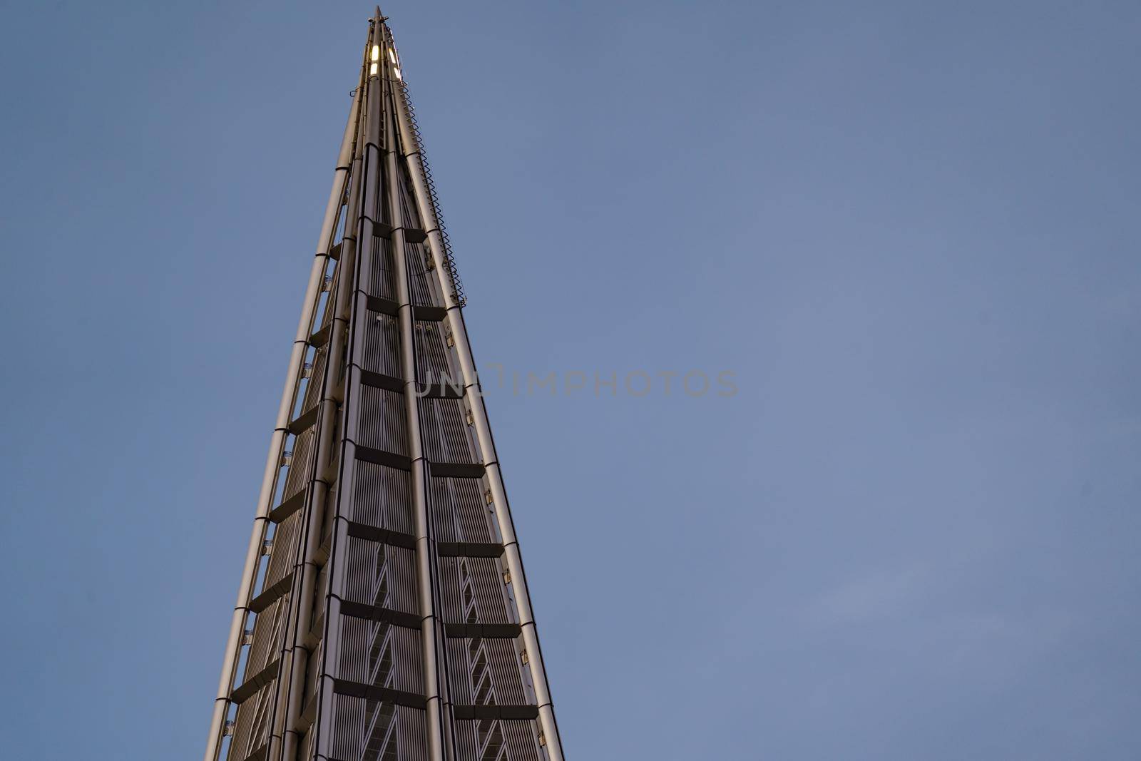 Russia, St. Petersburg, 10 June 2022: The spire of skyscraper Lakhta center of the gas company Gazprom at sunset, glass and iron facade. High quality photo