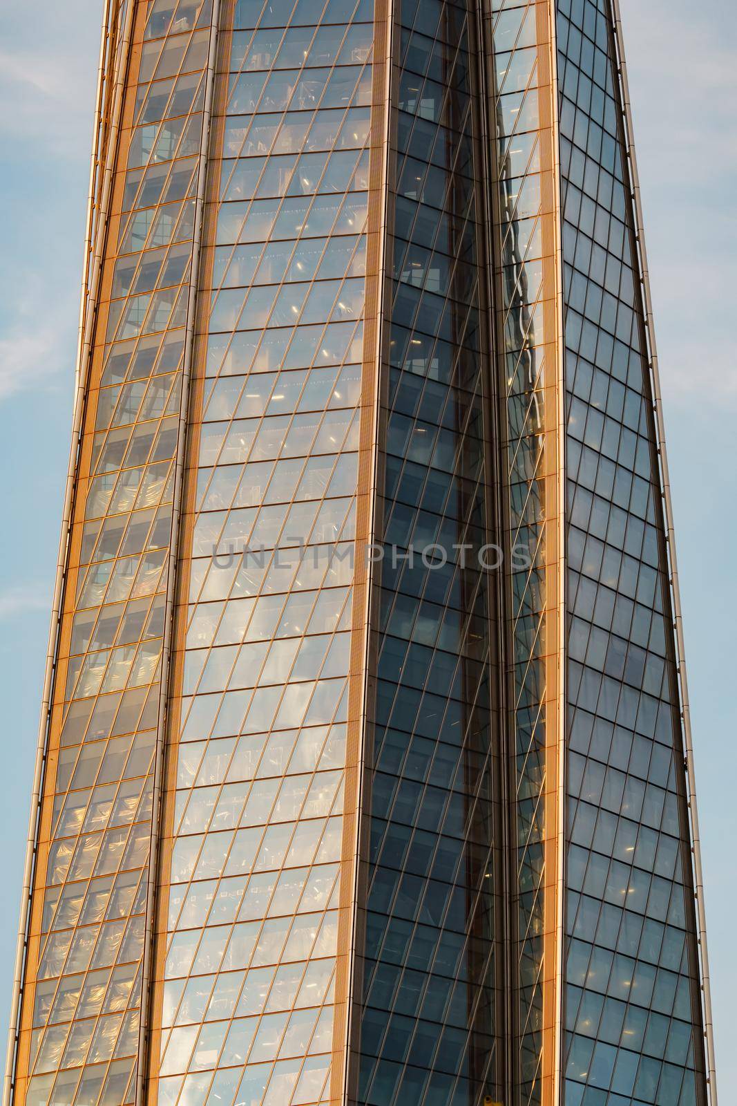 Russia, St. Petersburg, 10 June 2022: The skyscraper Lakhta center of the gas company Gazprom at sunset, glass and iron facade. High quality photo