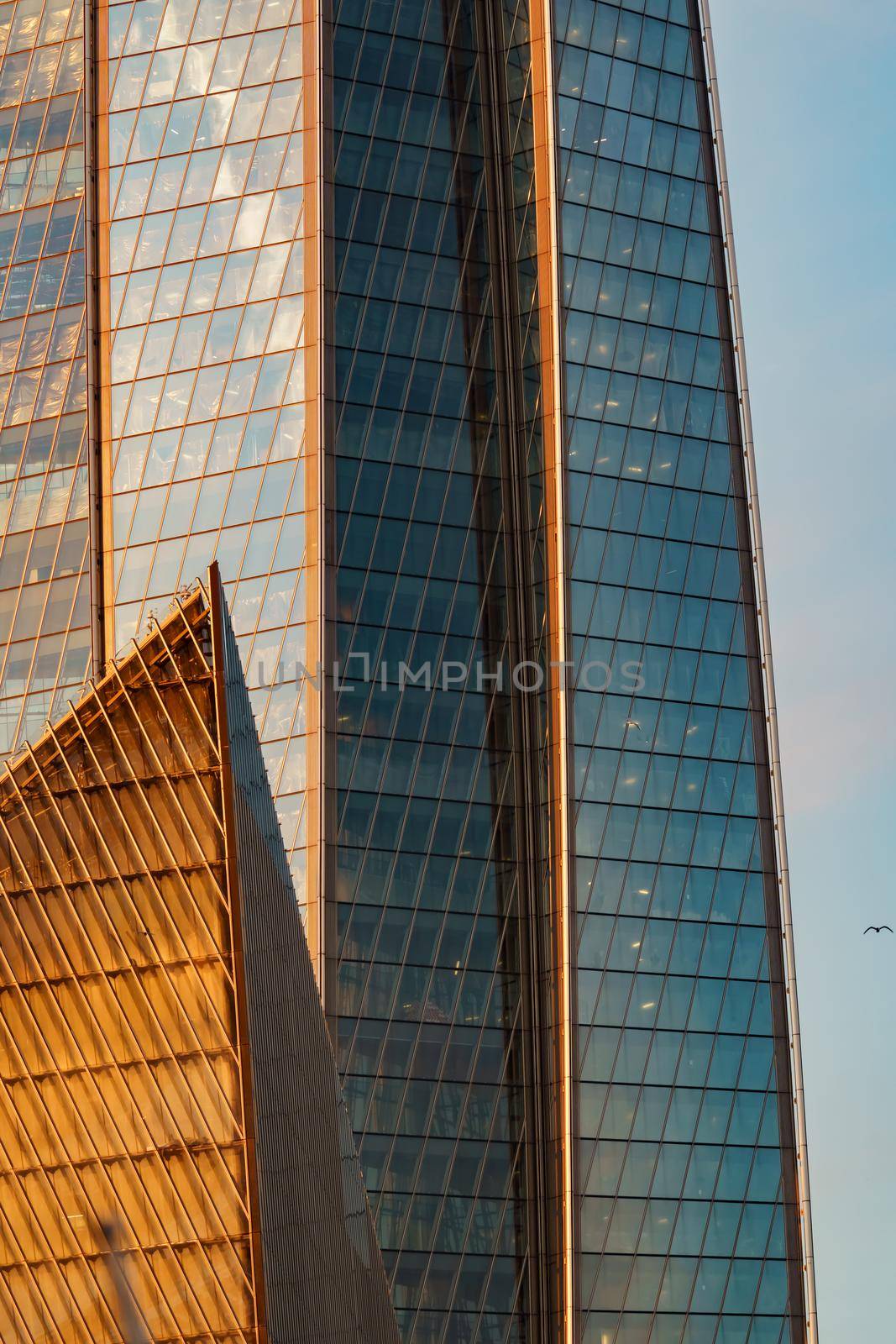 Russia, St. Petersburg, 10 June 2022: The skyscraper Lakhta center of the gas company Gazprom at sunset, glass and iron facade. High quality photo
