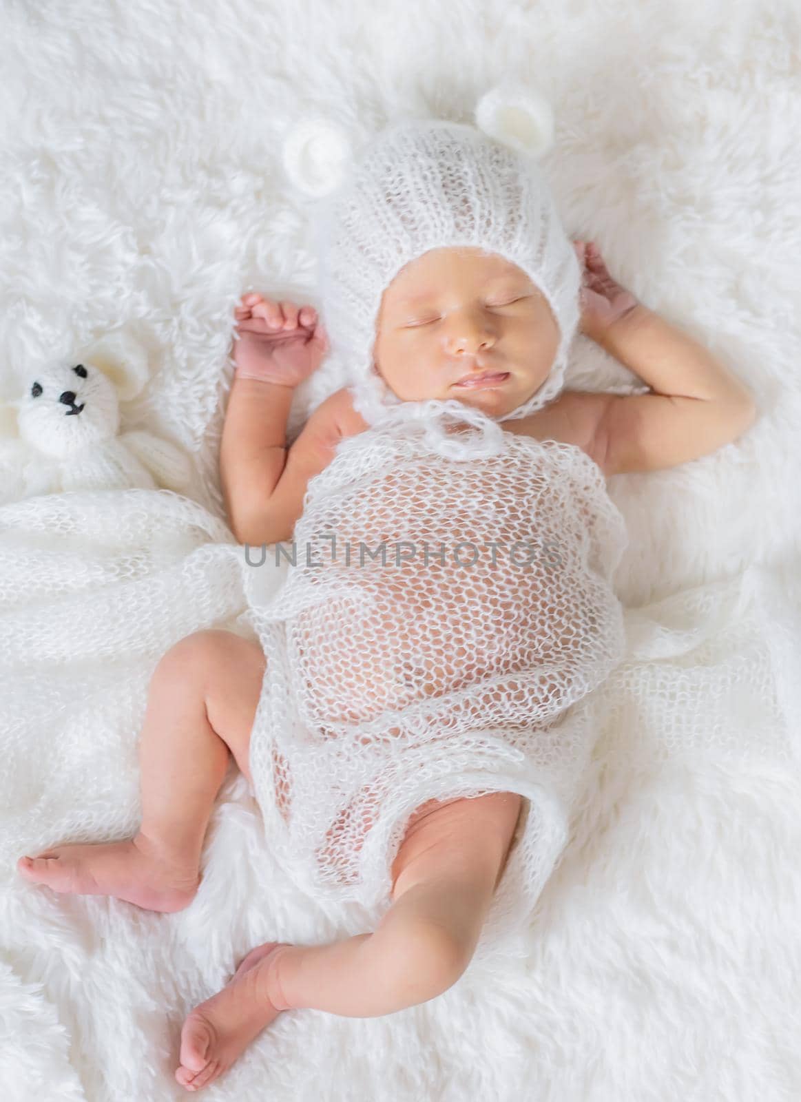 Newborn baby sleeps in a hat. Selective focus. people.