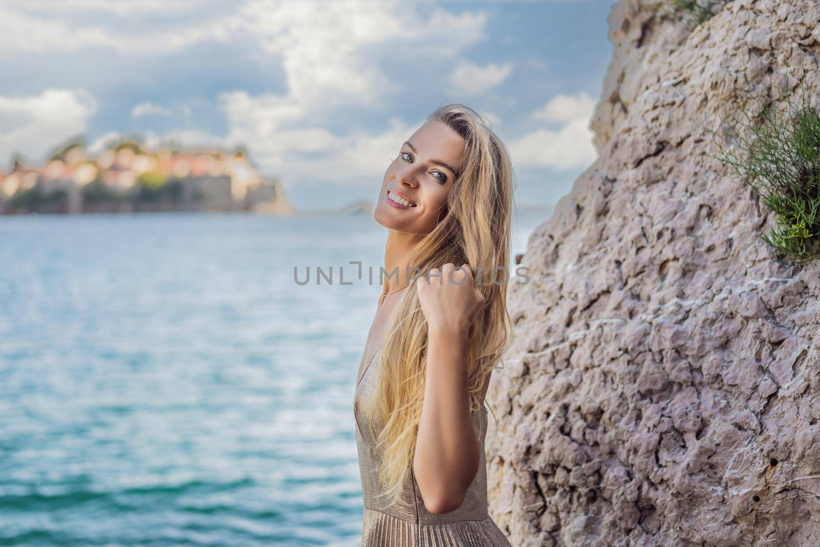 Woman tourist on background of beautiful view of the island of St. Stephen, Sveti Stefan on the Budva Riviera, Budva, Montenegro. Travel to Montenegro concept by galitskaya