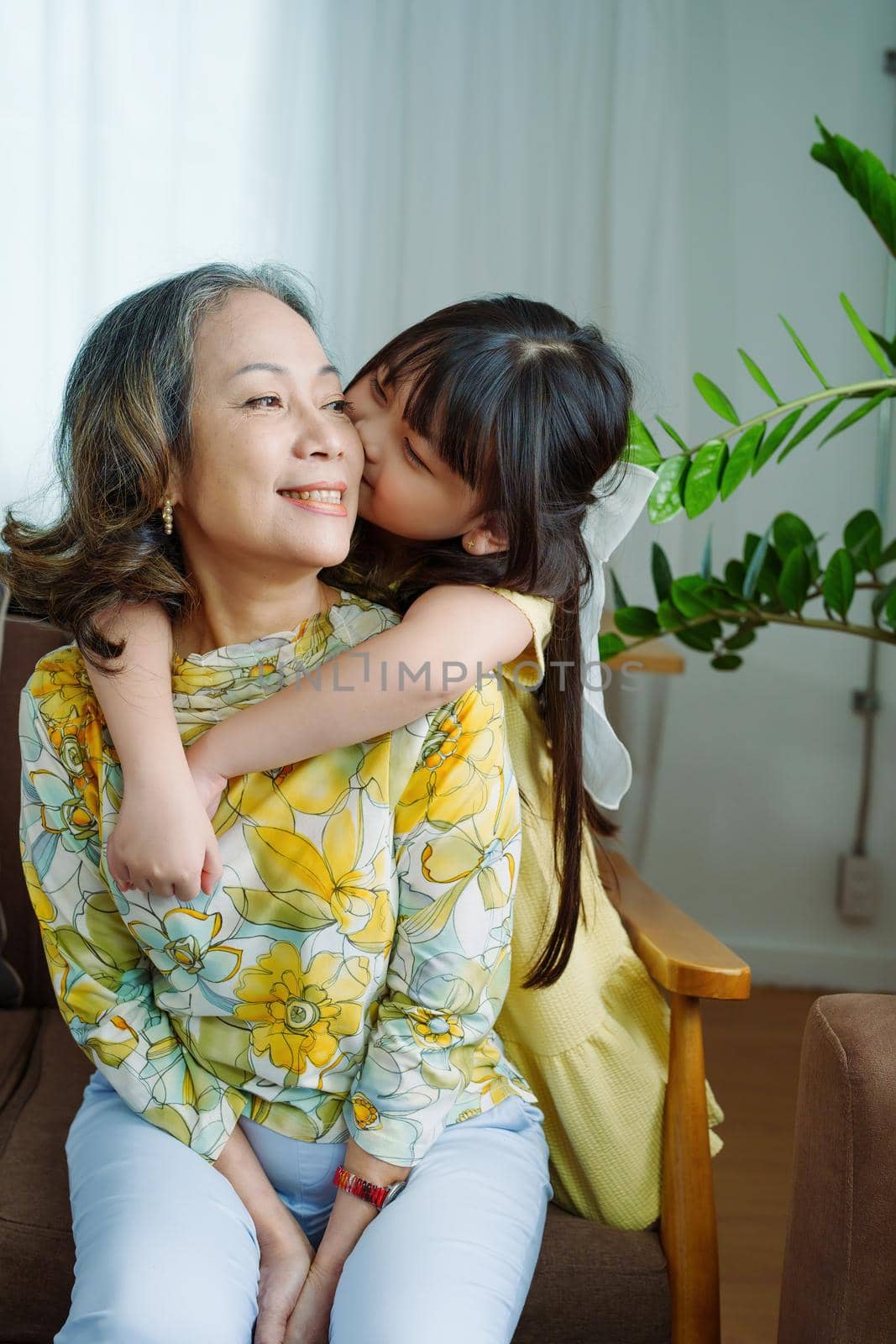 Asian portrait, grandma and granddaughter doing leisure activities and hugging to show their love and care for each other.