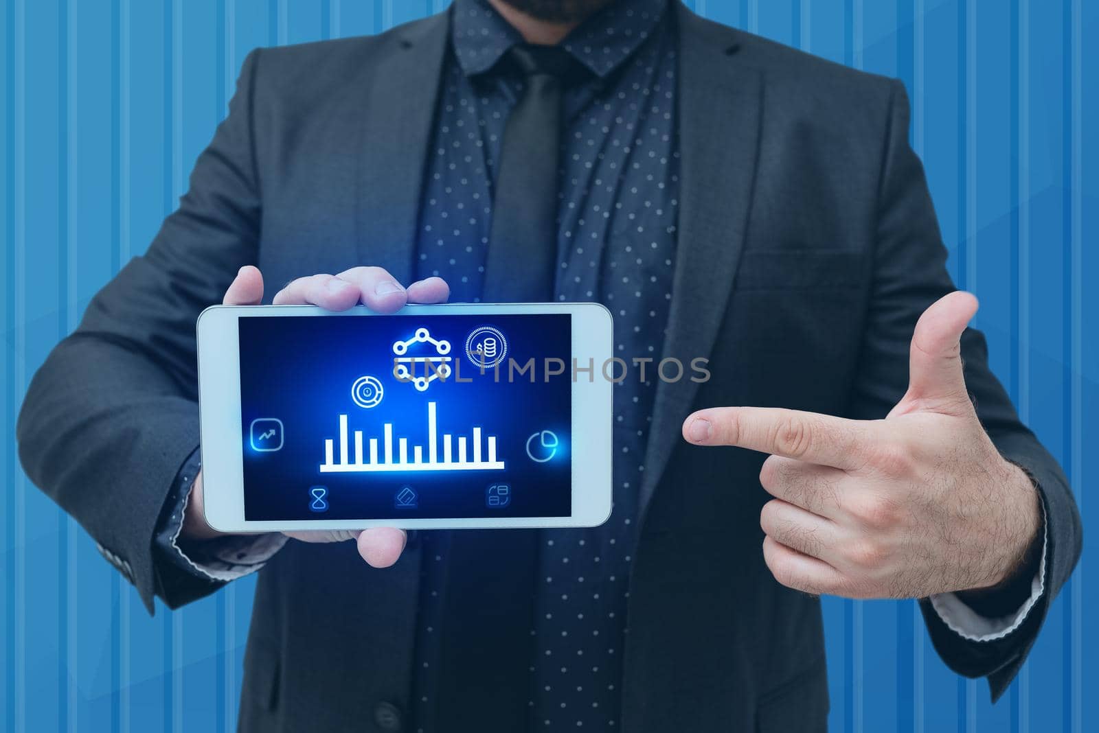 Man holding Screen Of Mobile Phone Showing The Futuristic Technology. Businessman Presenting Cell Phone Inside Room Presenting Modern Automation. by nialowwa