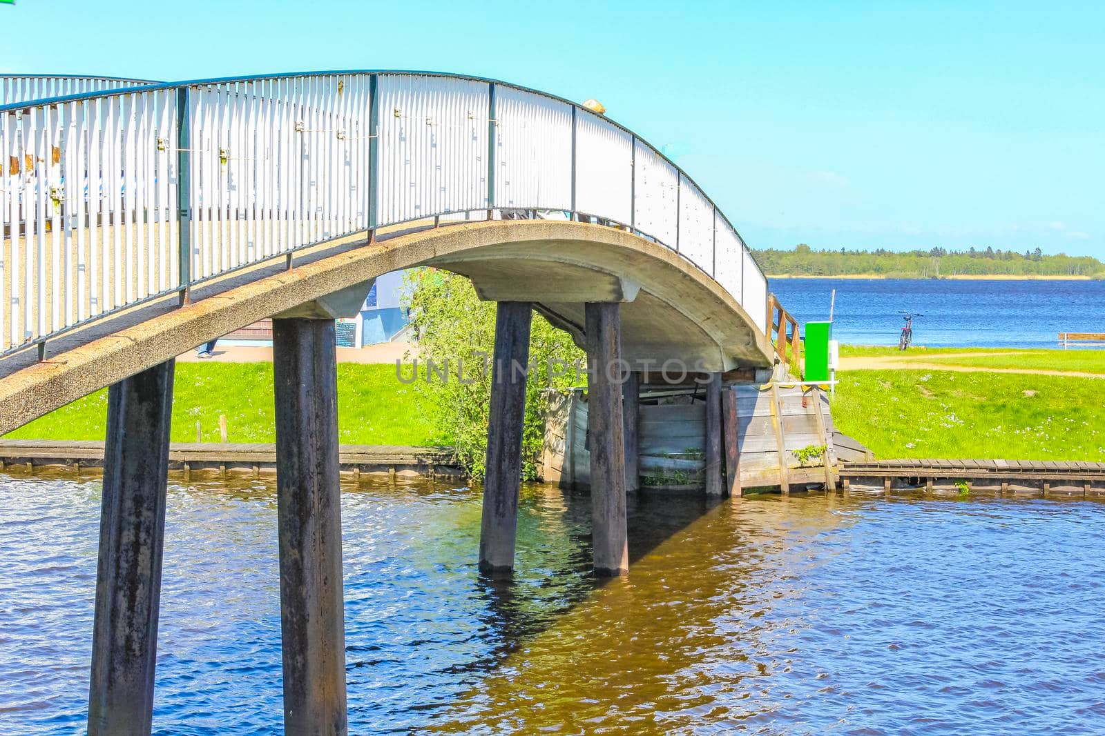 Bad Bederkesa Lake See bridge on sunny day and natural landscape in Geestland Cuxhaven Lower Saxony Germany.