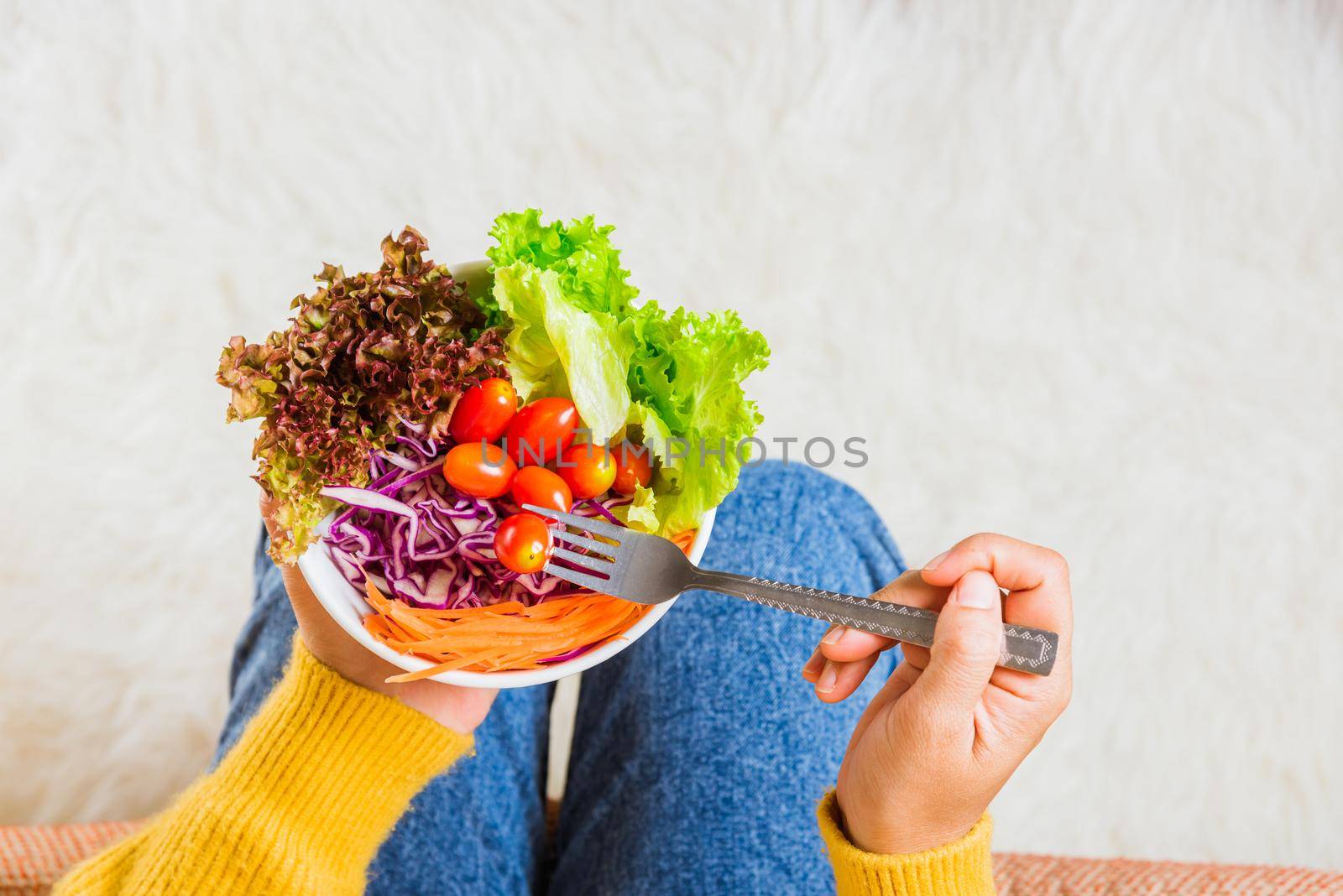 woman eating fresh salad meal vegetarian by Sorapop