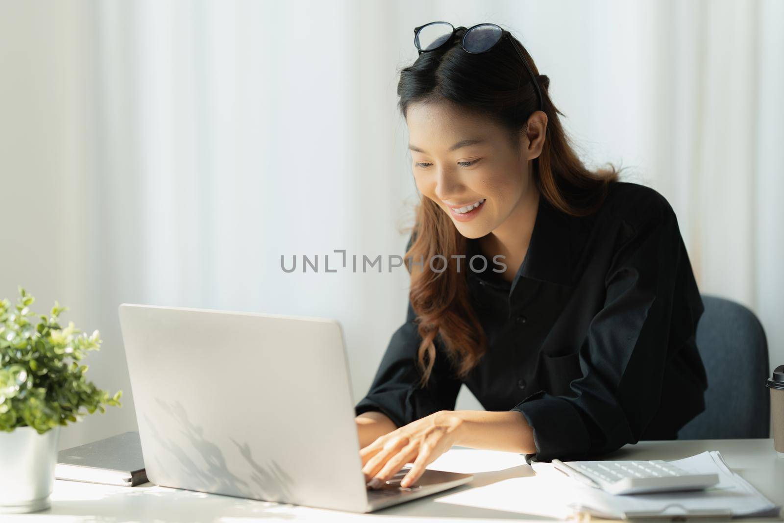 Charming Asian Business Woman working at office. Account and finance concept