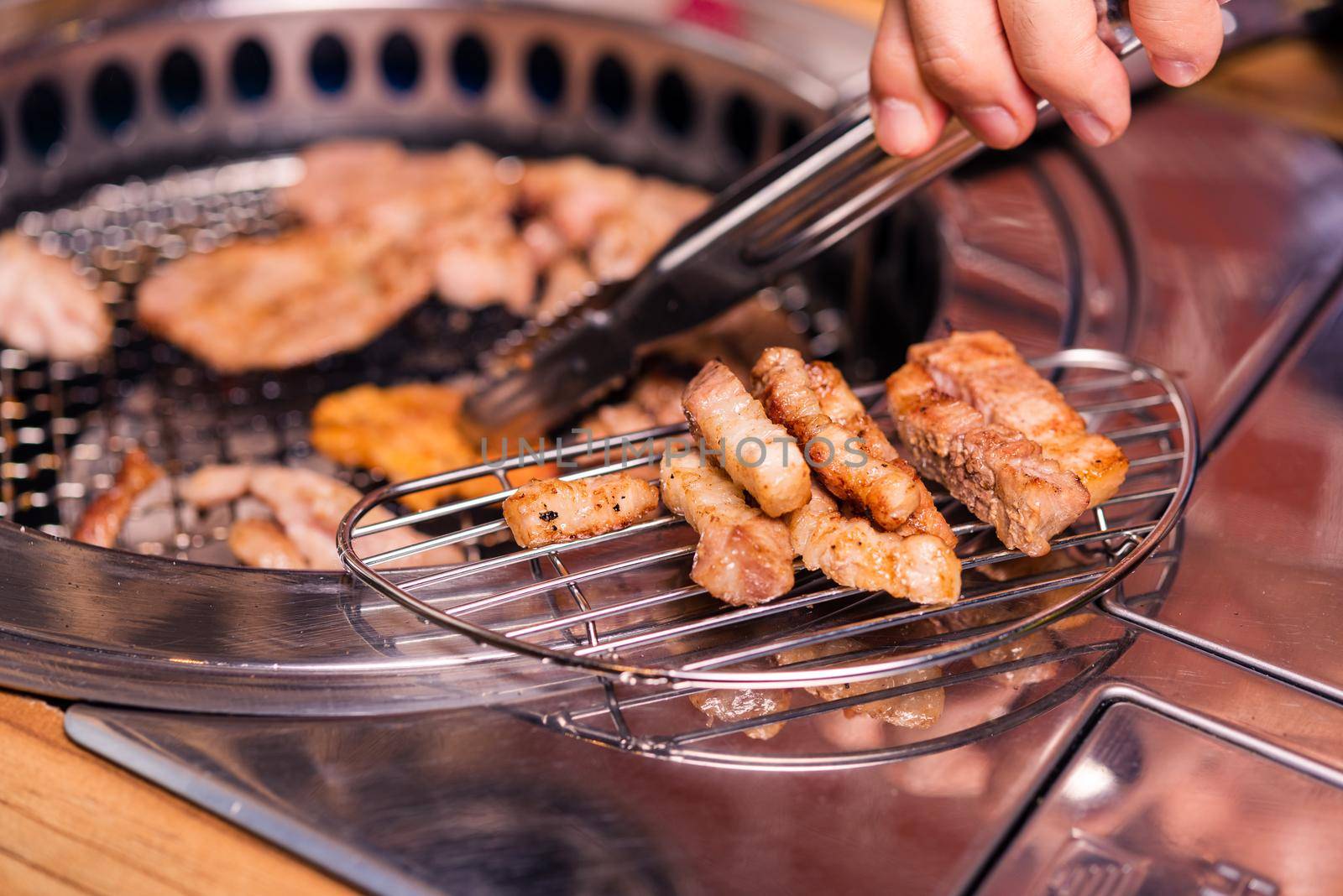 Korean beef barbecue on hot coals. Grilling meat pork Korean BBQ traditional style on stove serve in restaurant, Japanese food