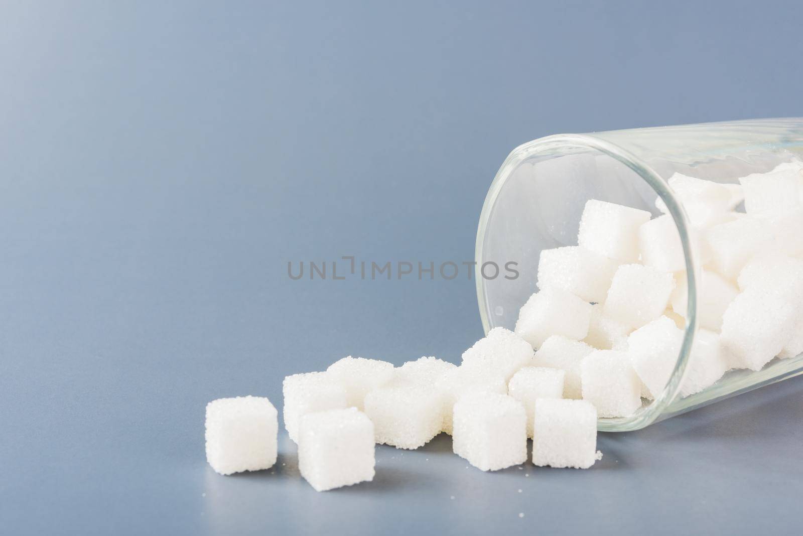 sugar cube sweet food ingredient spilled out of the glass by Sorapop