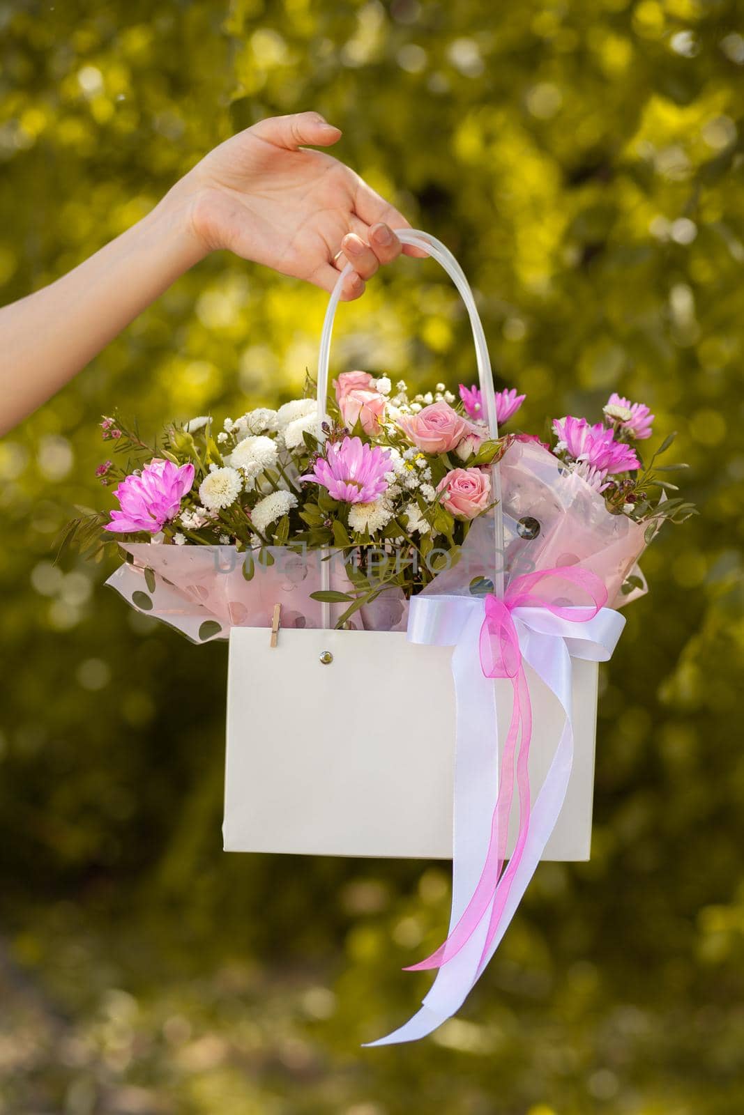 A beautiful bouquet of flowers in a box in the hands of a girl by AnatoliiFoto