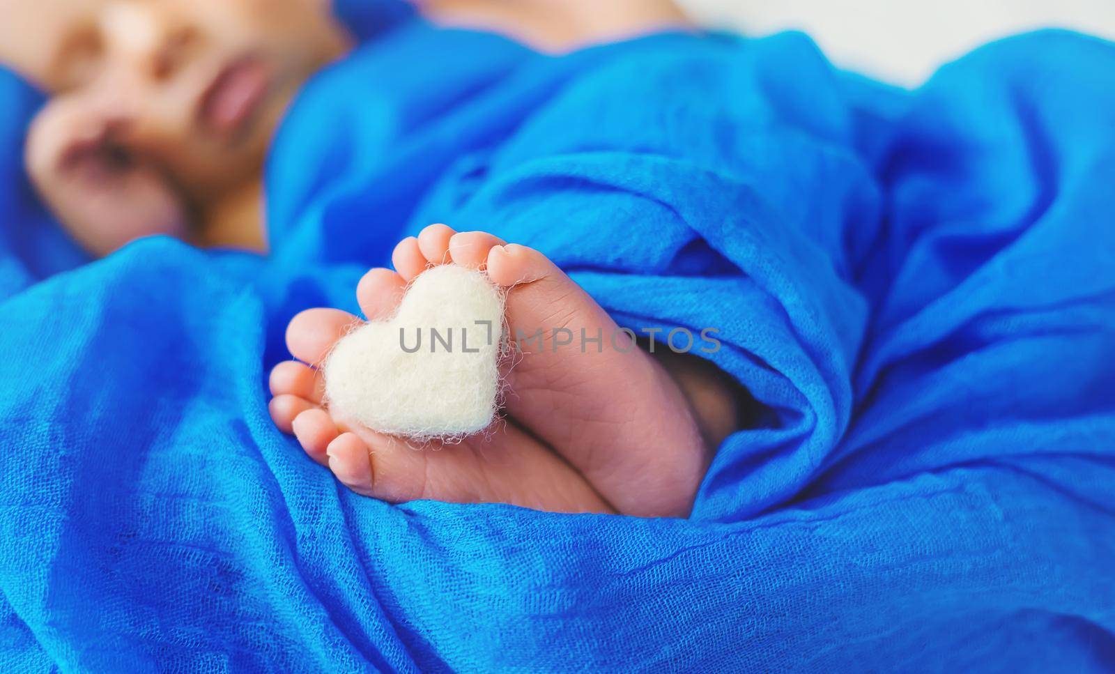 Newborn baby sleeping on a blue background. Selective focus. people.