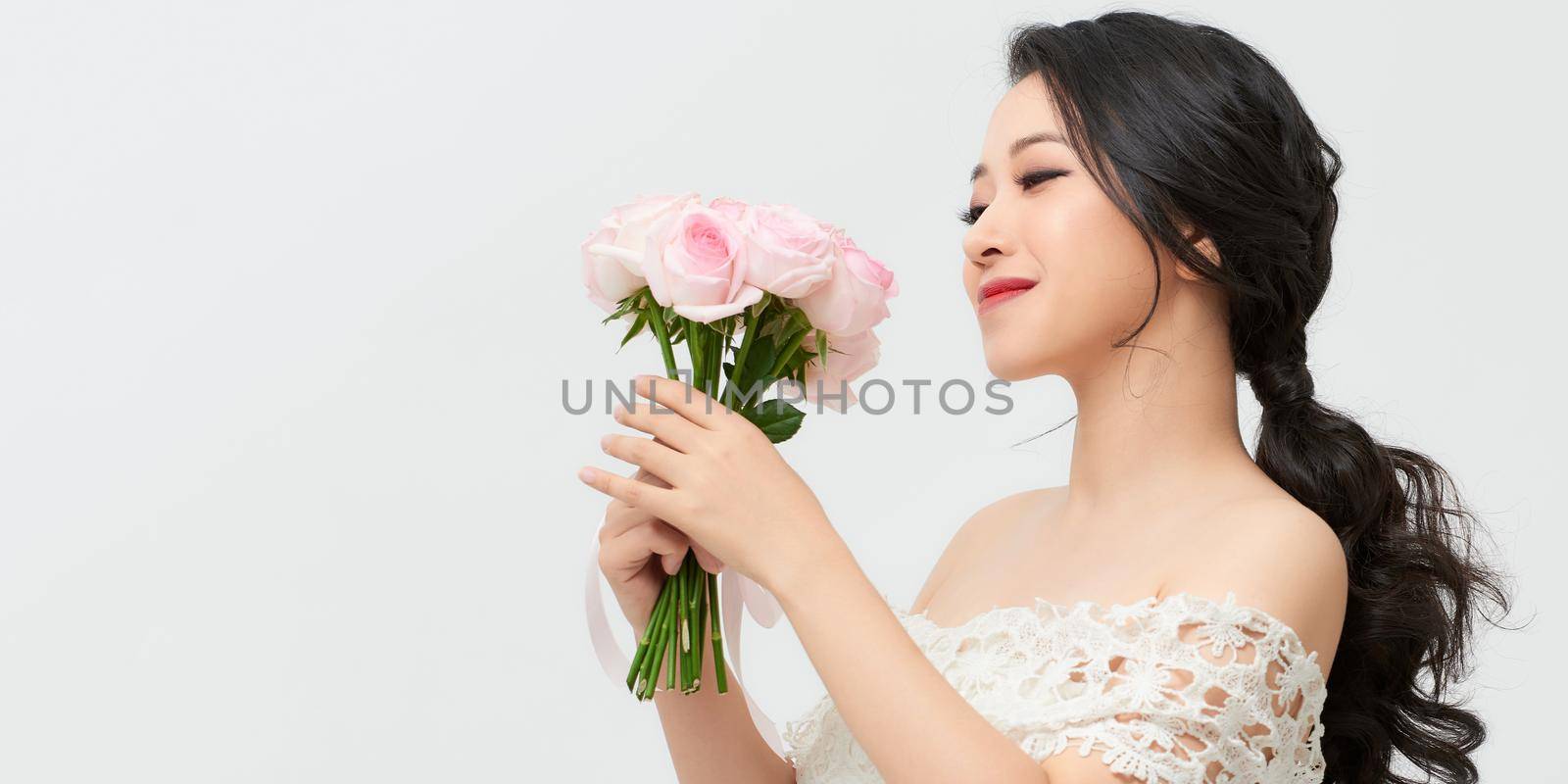 Woman with Spring Flower bouquet. Happy surprised model woman smelling flowers. Mother's Day. Springtime