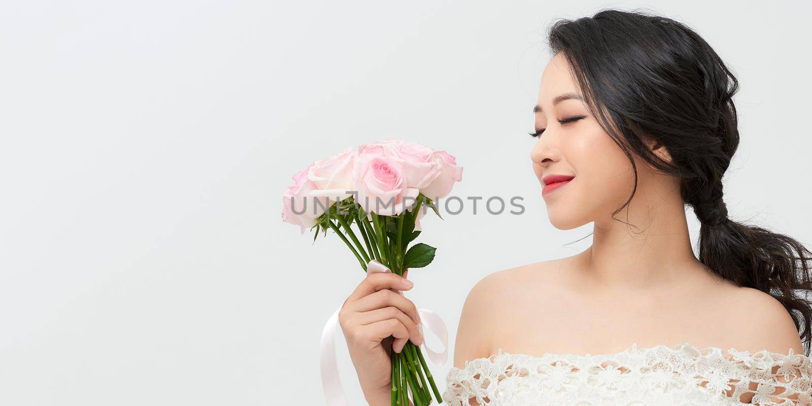 Portrait of a beautiful girl with a bouquet of roses. Beauty and fashion. by makidotvn