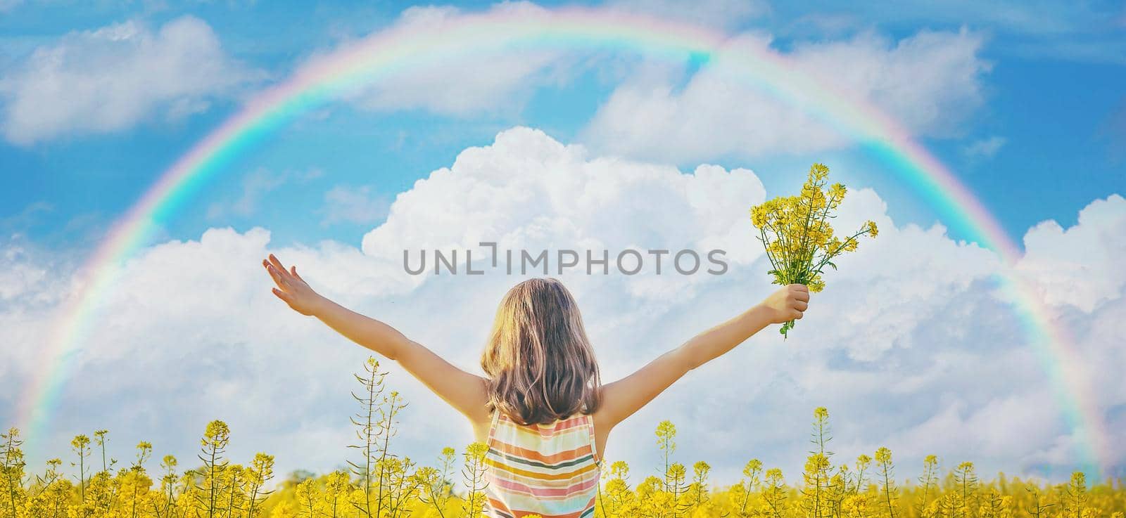 A child in a yellow rainbow field. Selective focus. by yanadjana