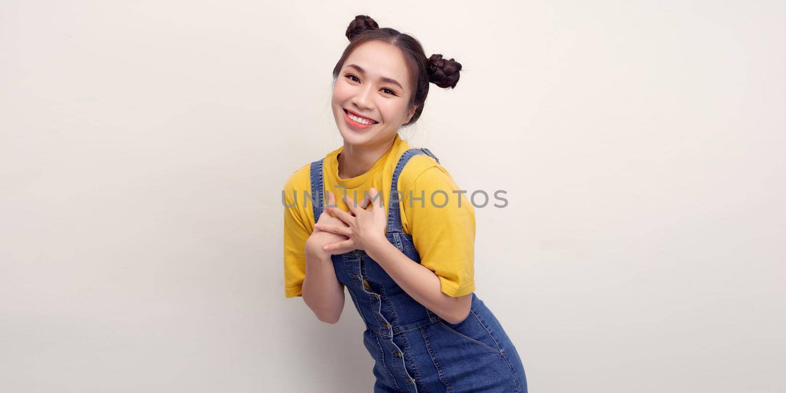 Image of excited girl expressing surprise with hands on her chest isolated over white background by makidotvn