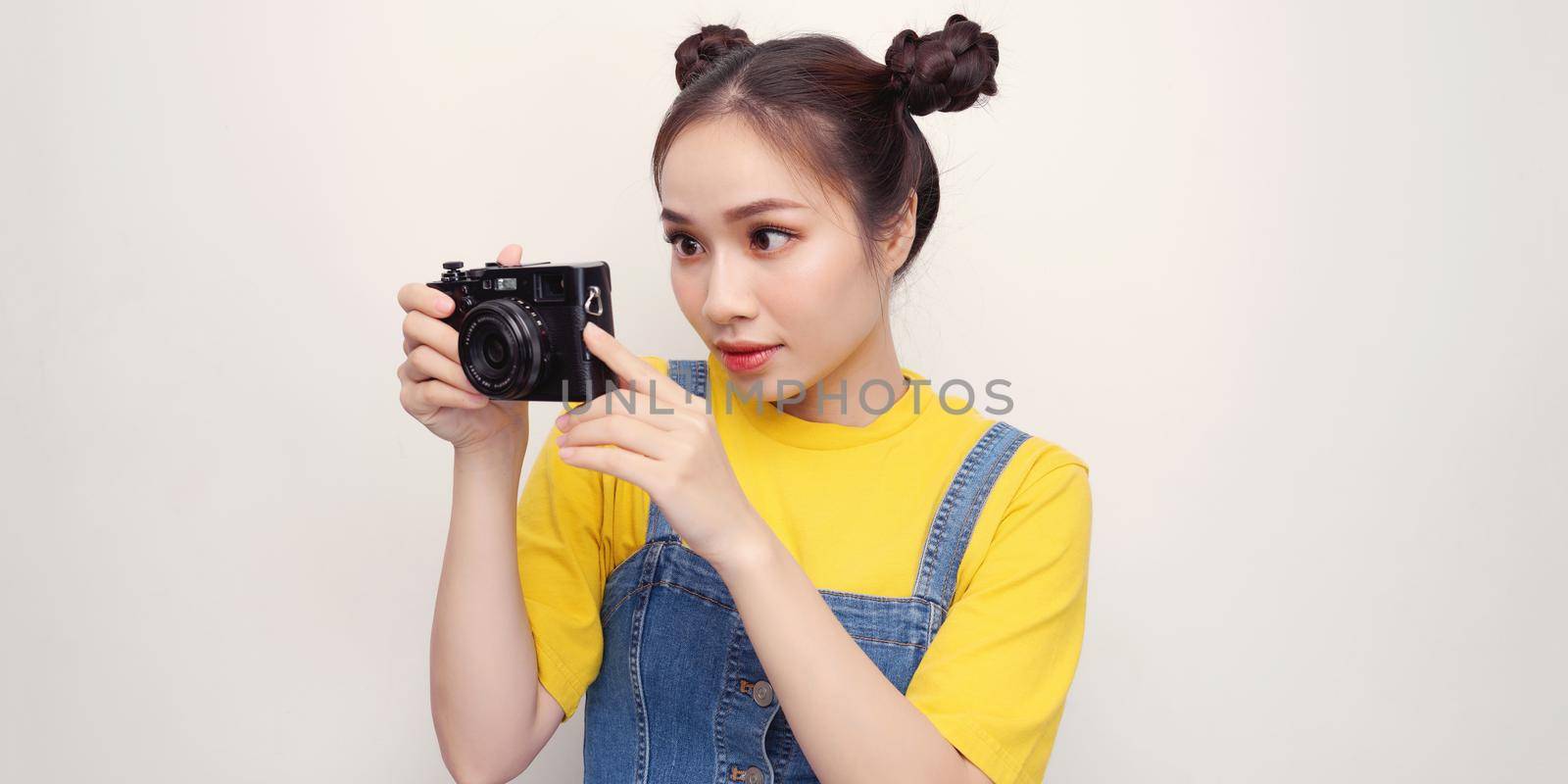 Asian woman using camera while smiling