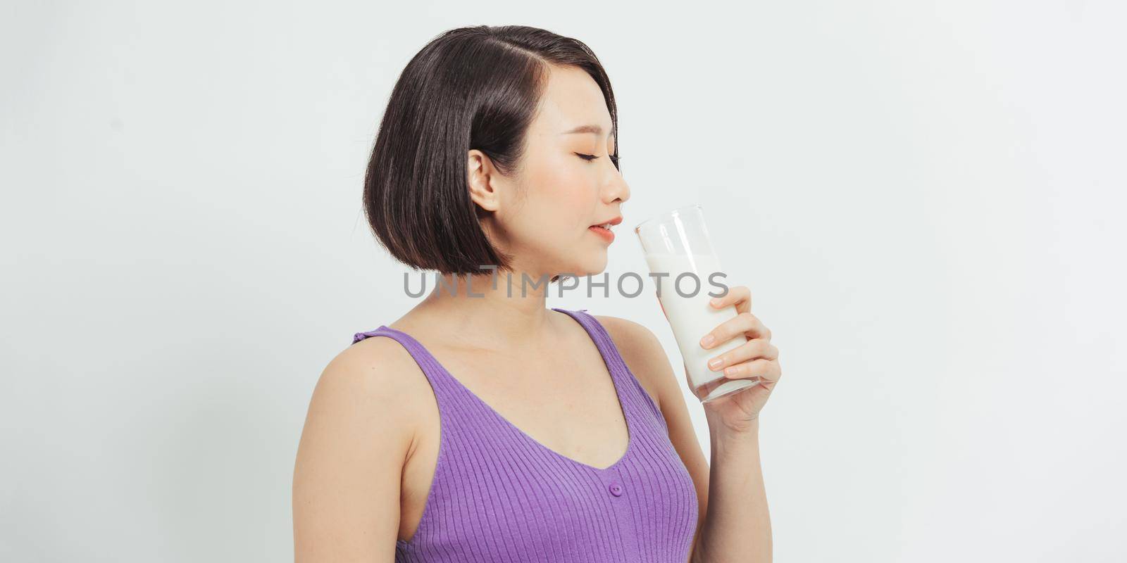 The pregnant girl drinks milk. isolated on white background
