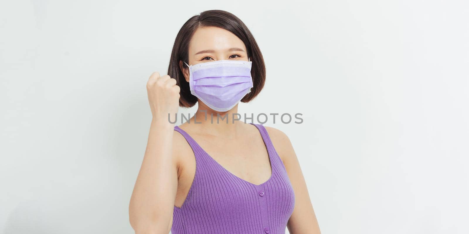 Young pregnant woman mother to be wearing protection mask for coronavirus disease with a happy and cool smile on face. Lucky person. by makidotvn