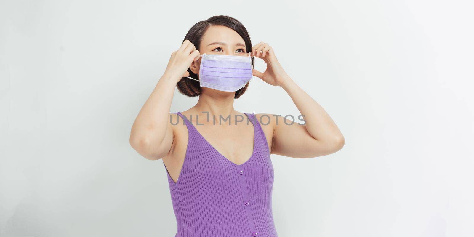 Pregnant woman with face medical mask on. Worries about child birth during pandemic.