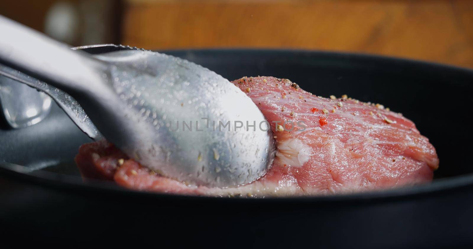 Pork Meat Seasoned is Frying in Hot Pan. Close Up cooking Professional Delicious Meat.