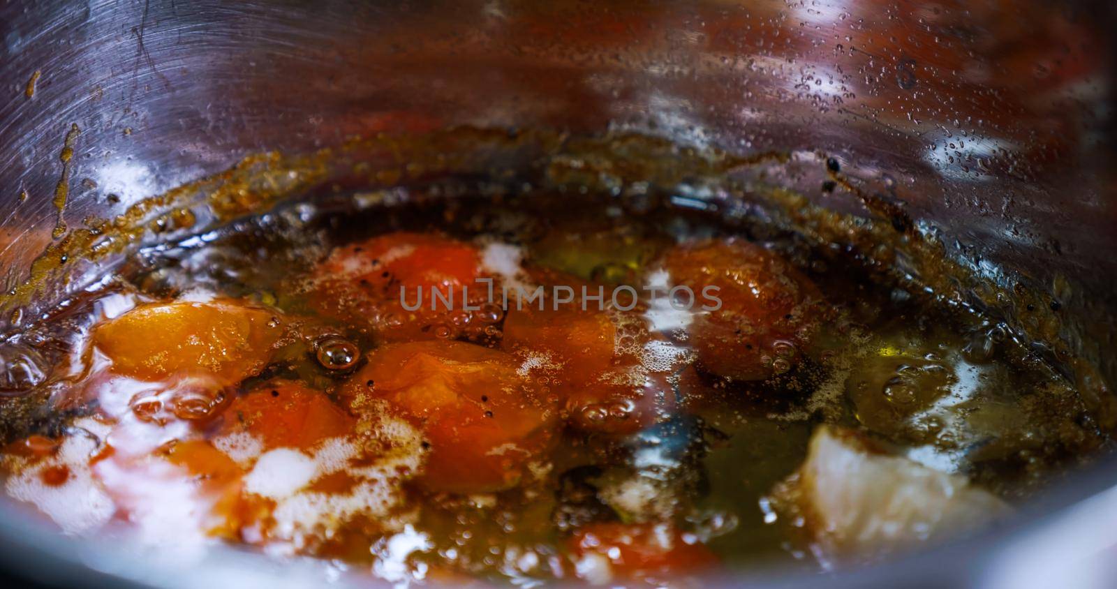 Tomatoes is Roasting in oil Professional Cooking