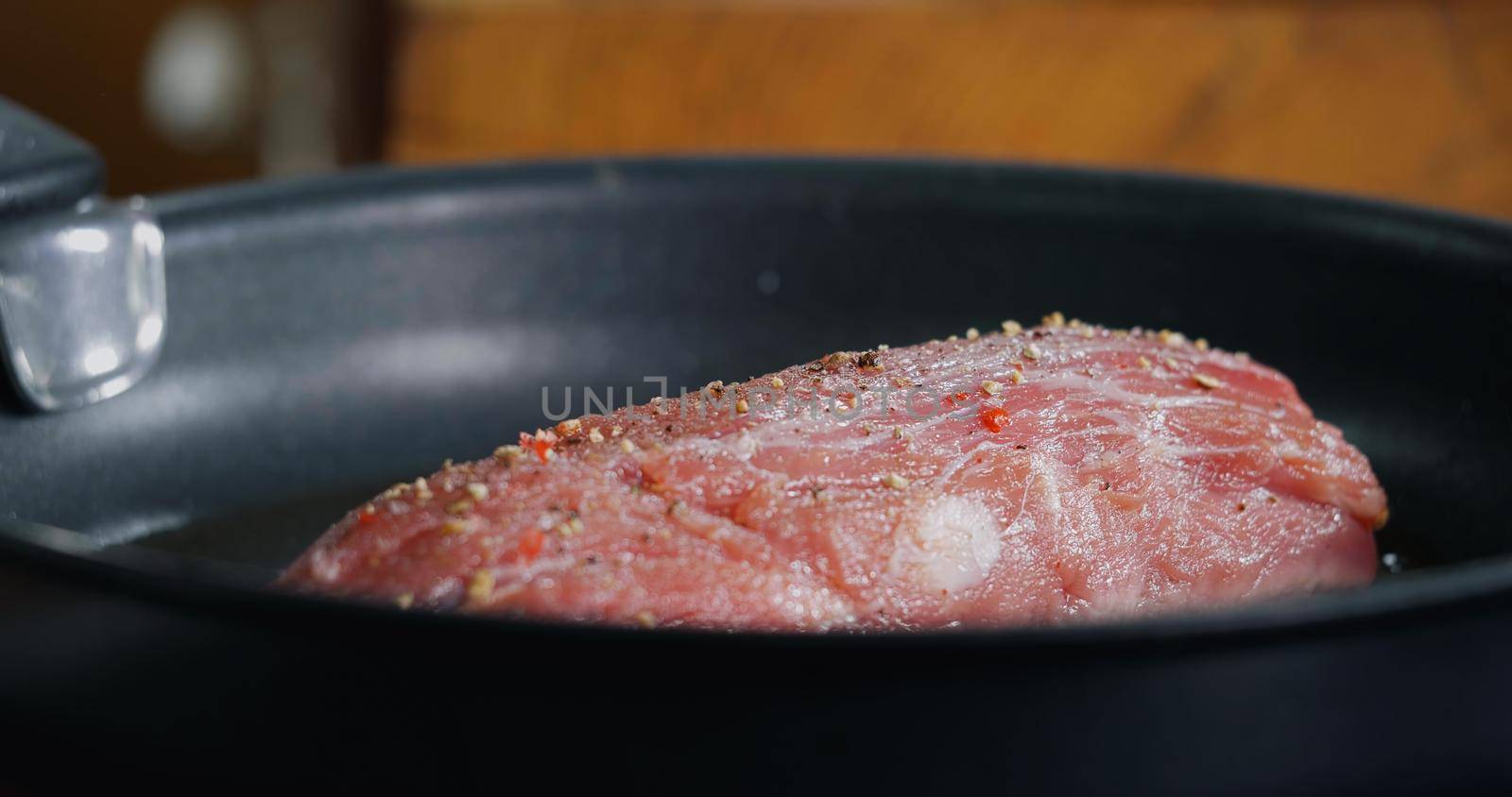 Pork Meat Seasoned is Frying in Hot Pan. Cooking Professional Delicious Meat.