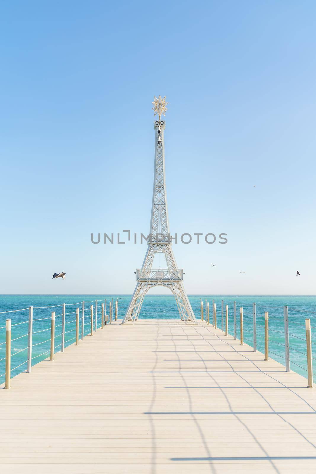 Large model of the Eiffel Tower on the beach. by Matiunina