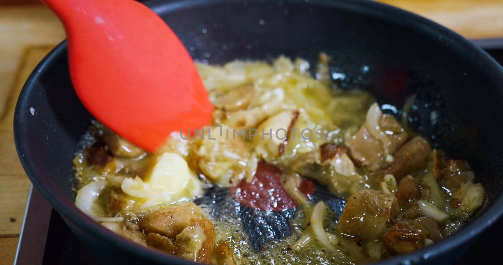 Cooking Tasty Meal Concept. Frying Mushroom Boletus and Onion in a Hot Pan