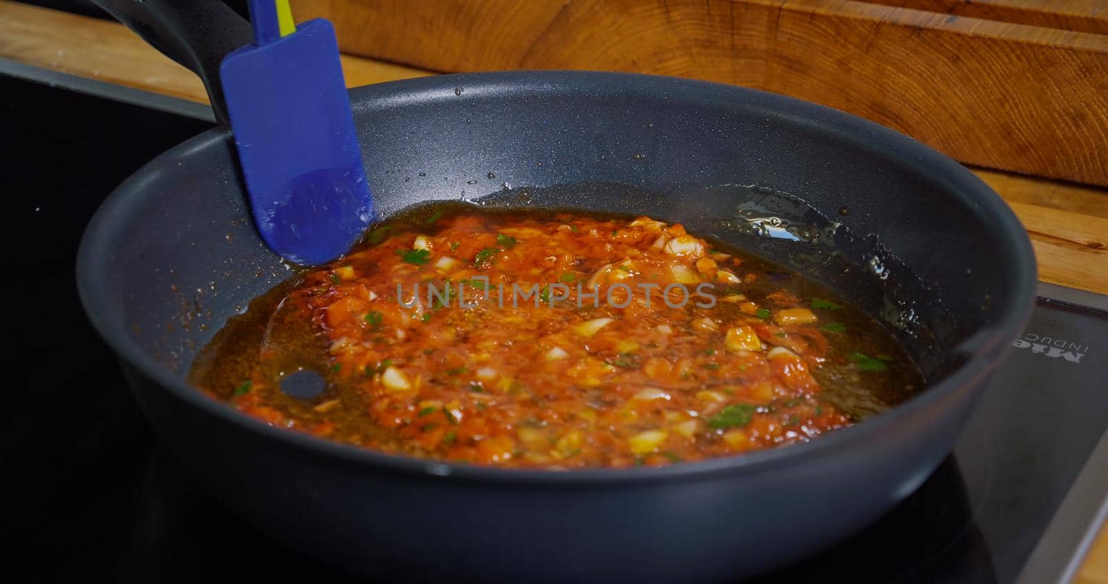 Preparing a Sauce from Tomato Paste and Onion at pan. Appetizing Food Process