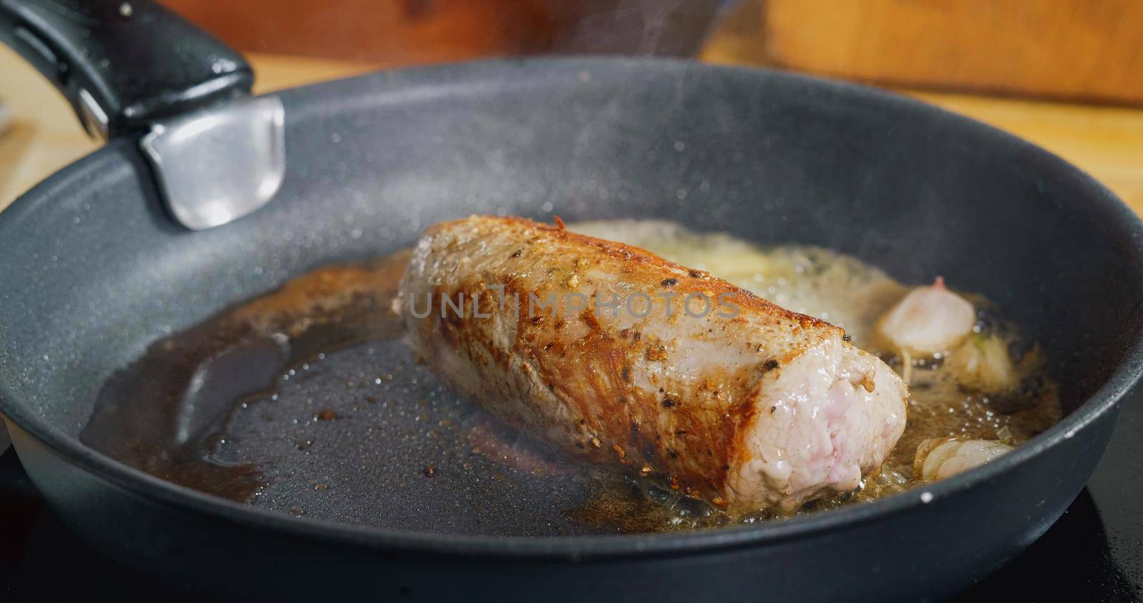 Seasoning with Falling Herbs on Fresh Fried Pork Meat. Professional Cooking. Spectacular images from kitchen.