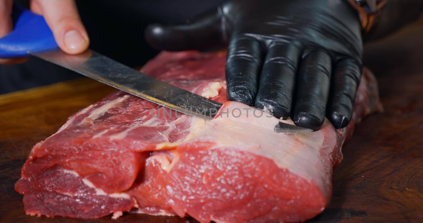 Cutting Portions of Fresh Raw Beef Meat As Preparation Before Cooking. Juicy Fresh Meat.