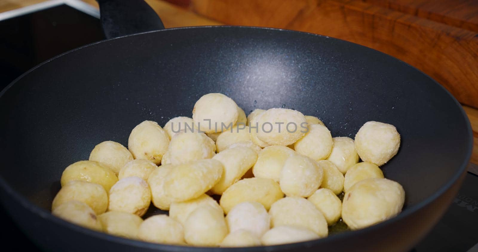 Young Potatoes cooking in Pan. Frying Fresh Baby Potatoes.
