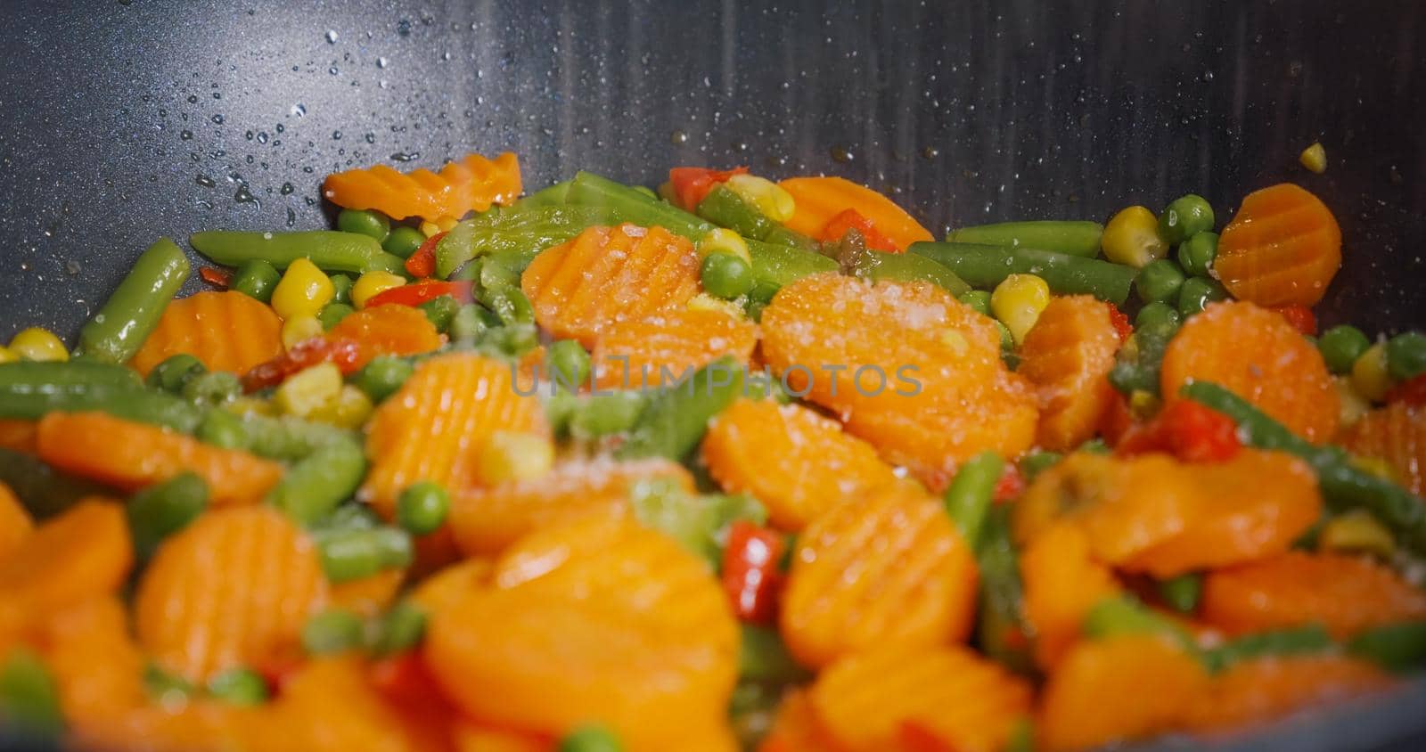 Season the vegetables cooked in a pan with salt.