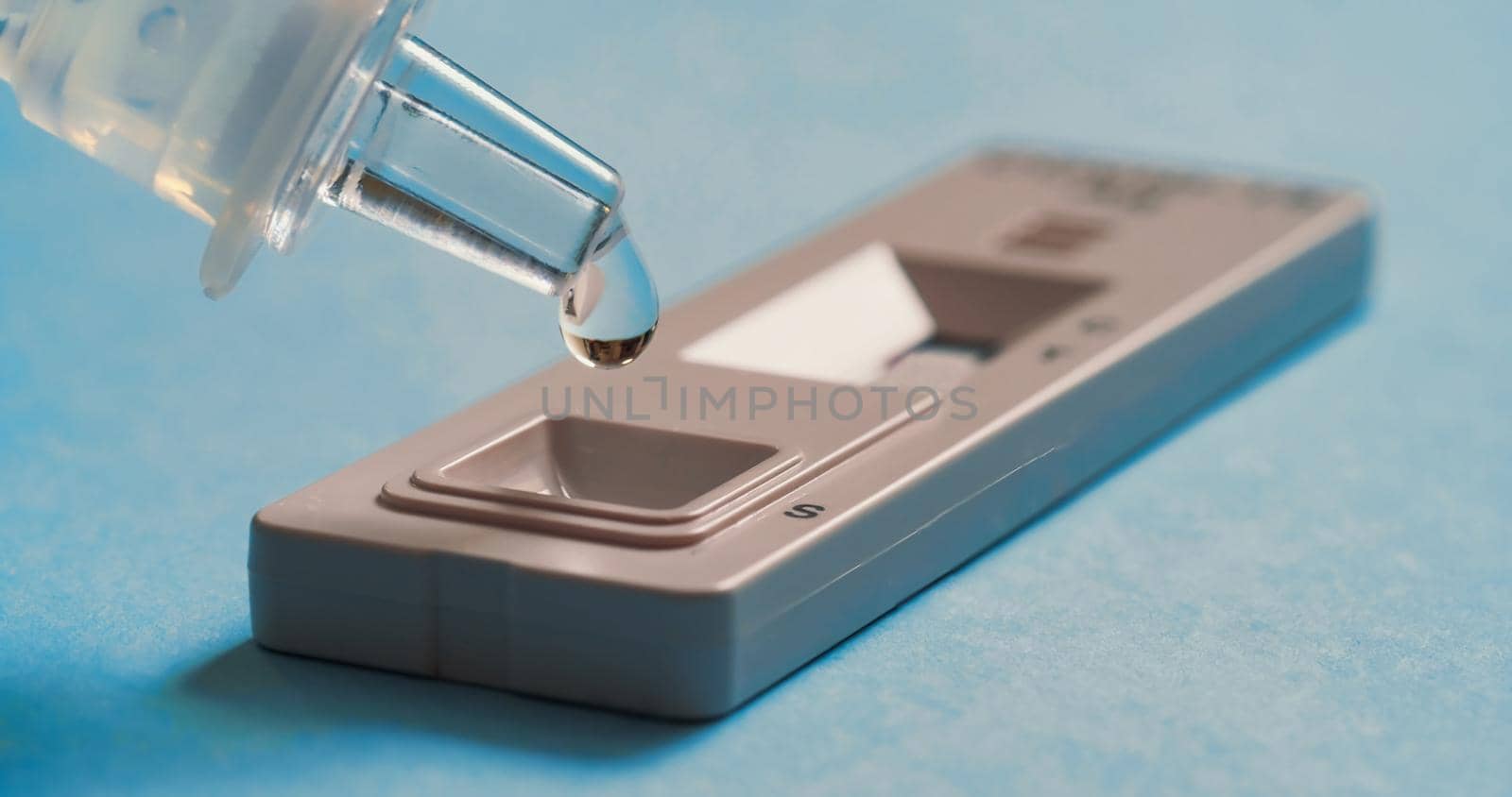 Liquid drops into cassette of Coronavirus Covid-19. by RecCameraStock