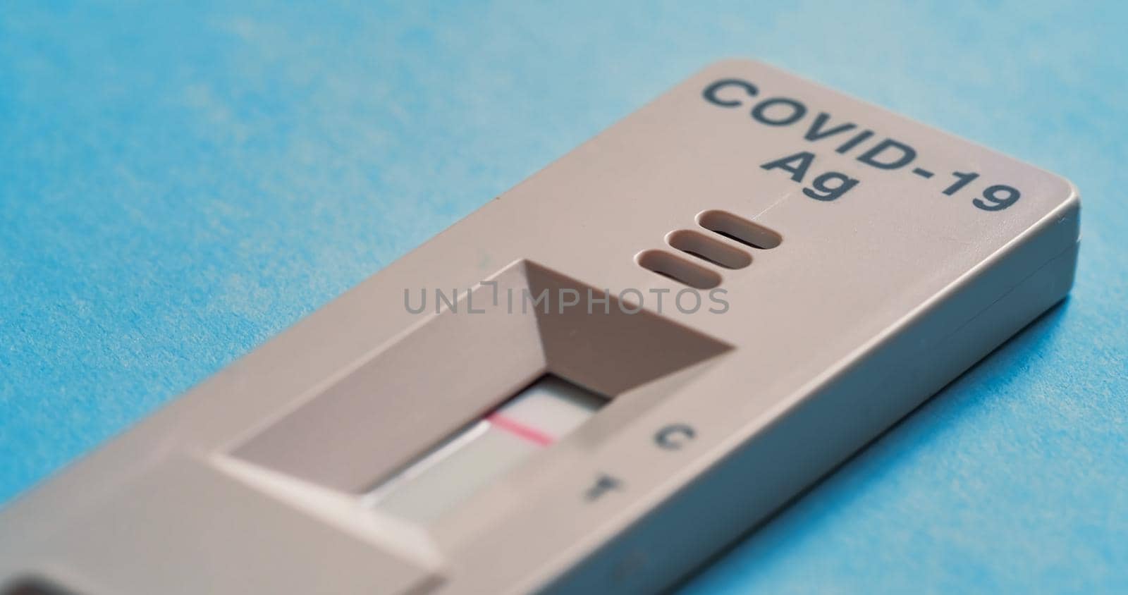 Covid-19 Antigen Test on a blue background. by RecCameraStock