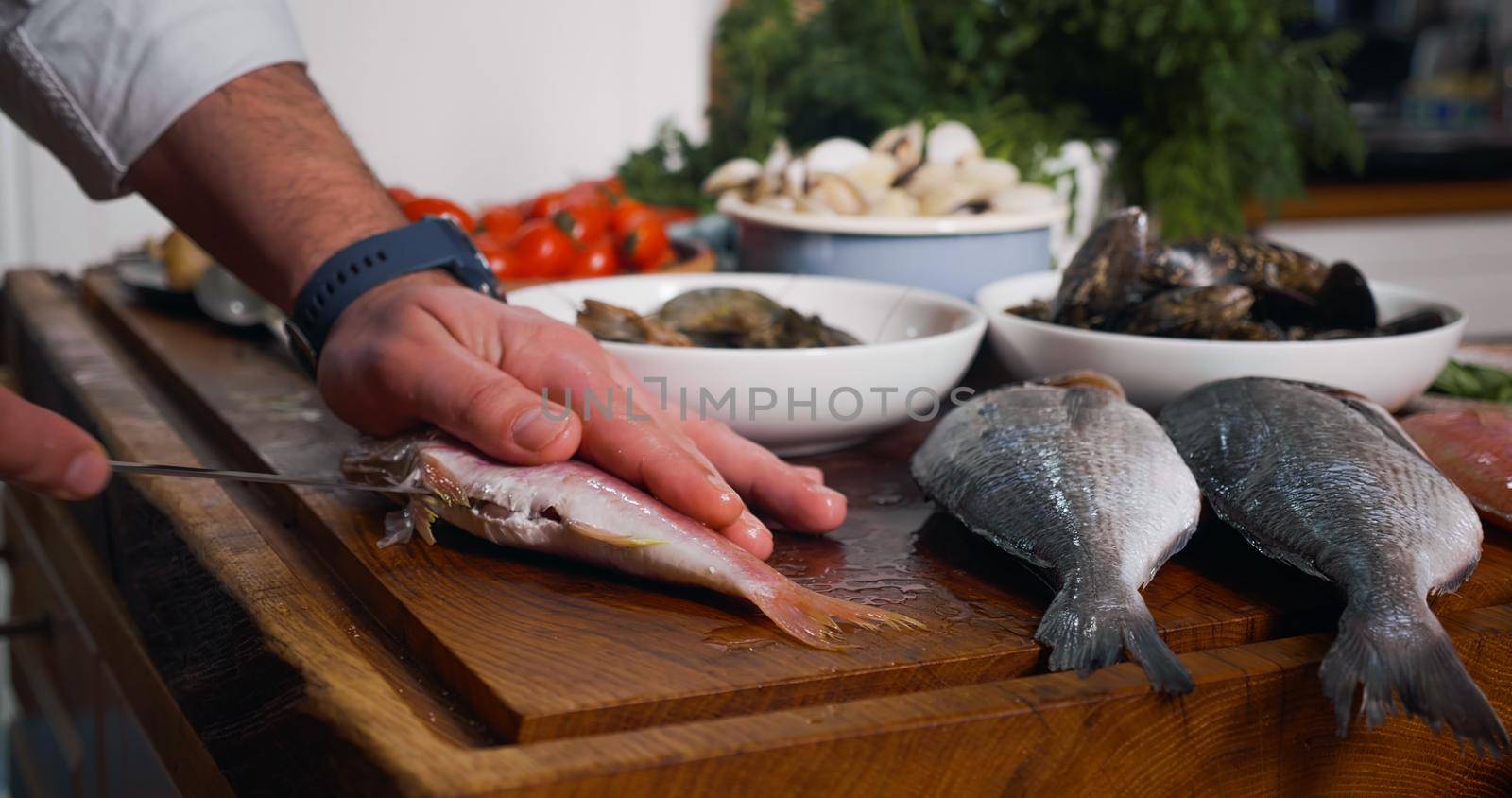 Cleaning Fish Before Cooking. Sea Food on a wood chipper