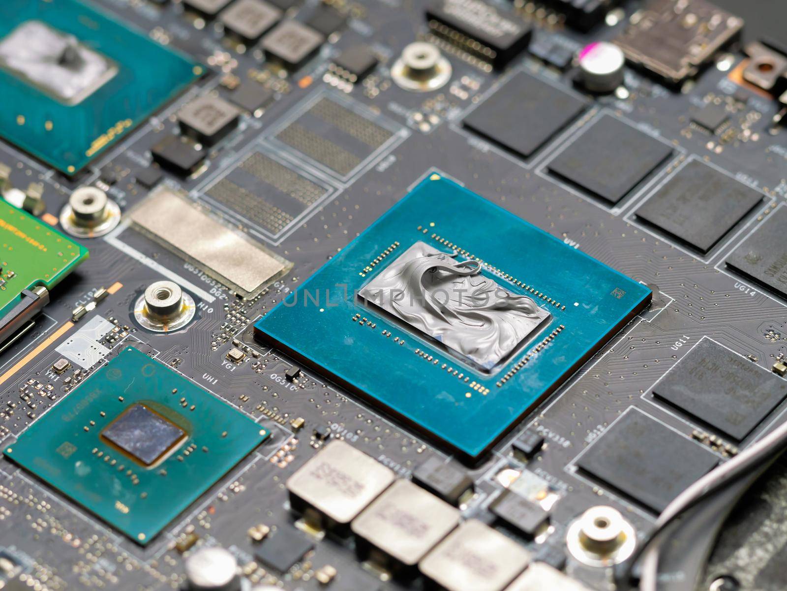 Applying thermal paste to a laptop processor, cooling computer components. by RecCameraStock