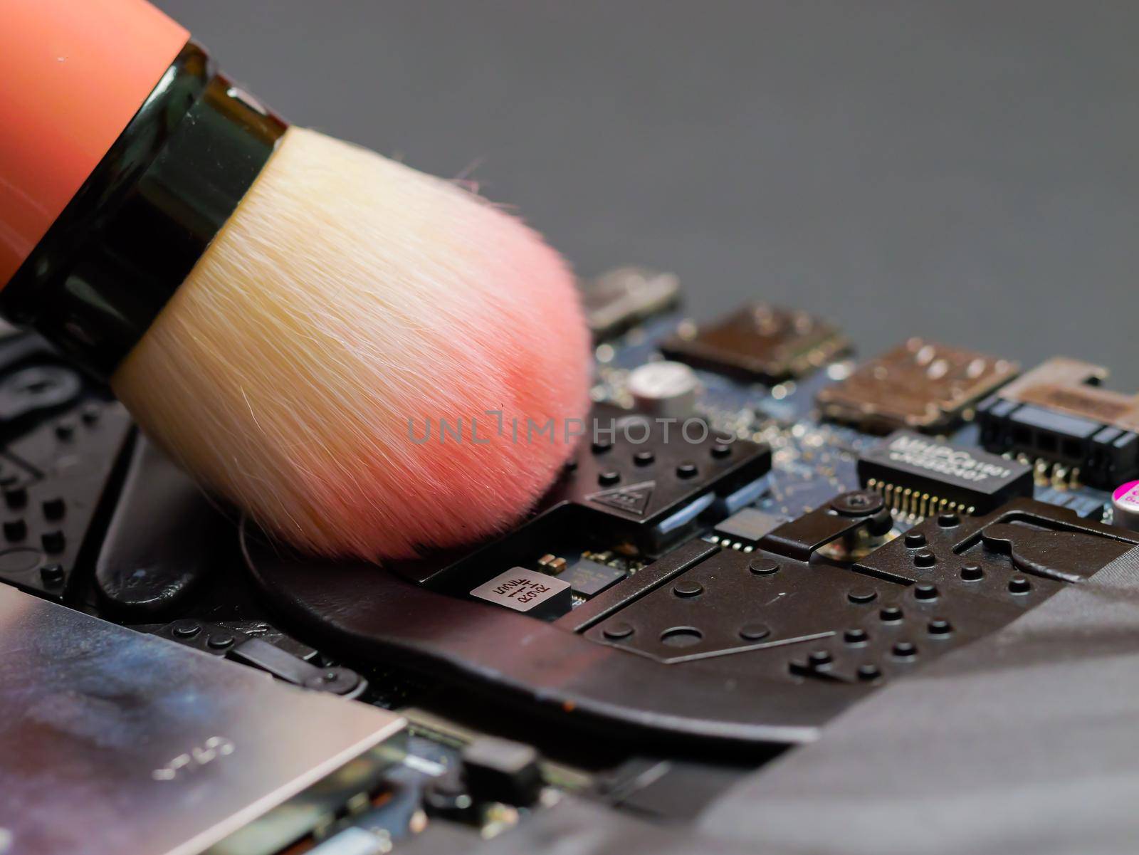 Macro of a brush cleaning a laptop fan. by RecCameraStock